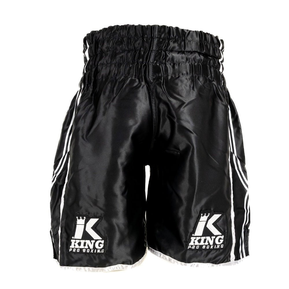 Détail de la taille élastique avec cordon de serrage interne et logo KING brodé du short XK noir.