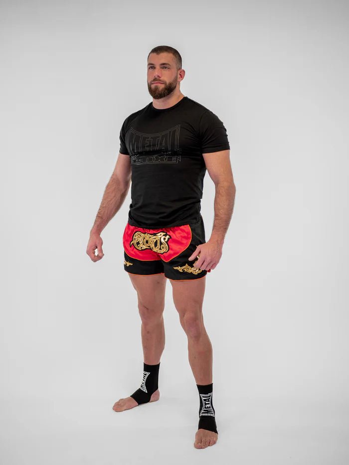 Detail bočních rozparků a výšivky červených pánských thajských kraťasů Lumpinee Metal Boxing
